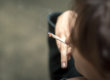 A person holding a cigarette in their hand.
