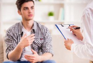 A teen talks to his counselor about his interest in a recreational therapy program