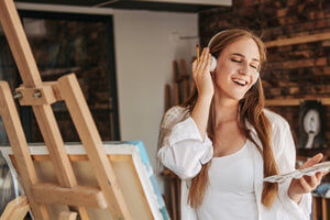 Woman enjoys her music and art therapy program